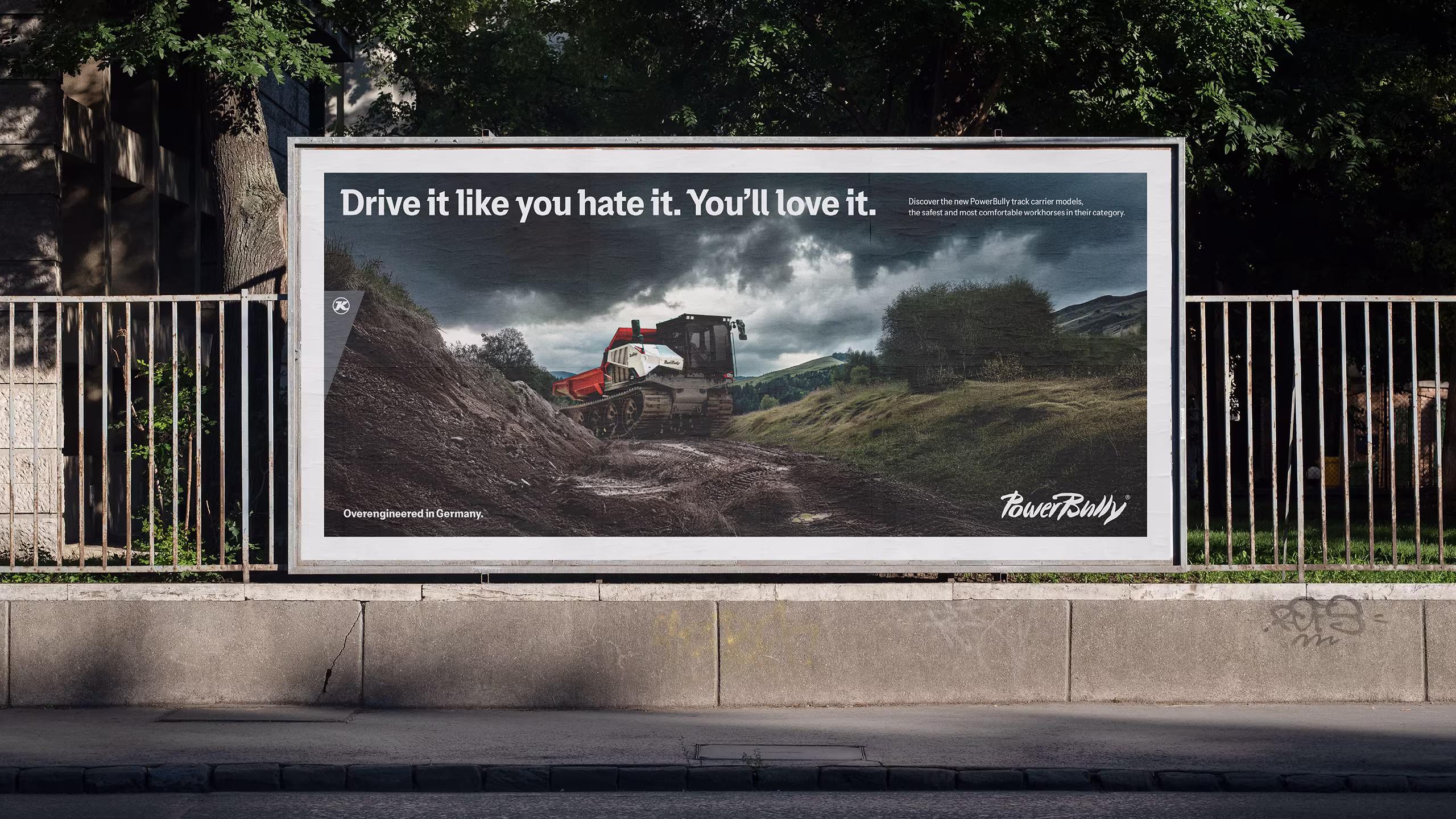 Straßenplakat mit PowerBully-Fahrzeug auf unwegsamem Gelände und dem Text „Drive it like you hate it. You’ll love it.“